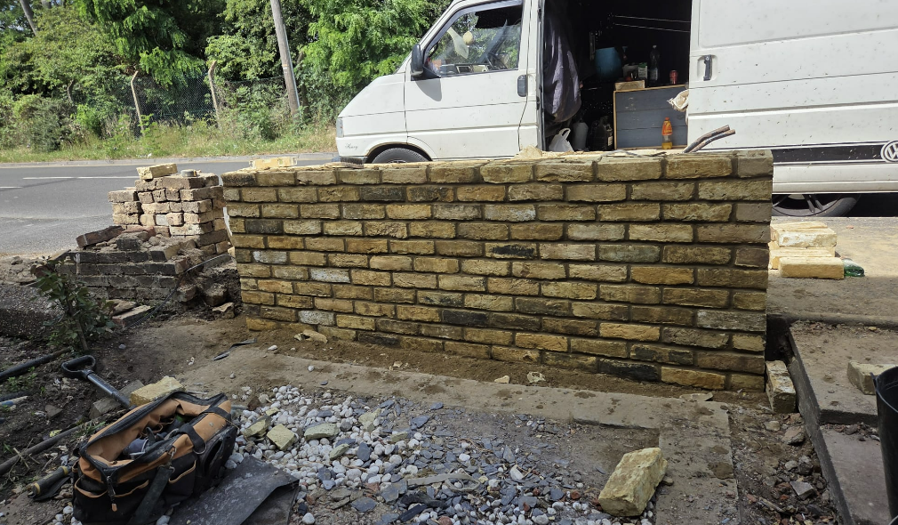 Reclaimed stock-brick garden wall built to road level