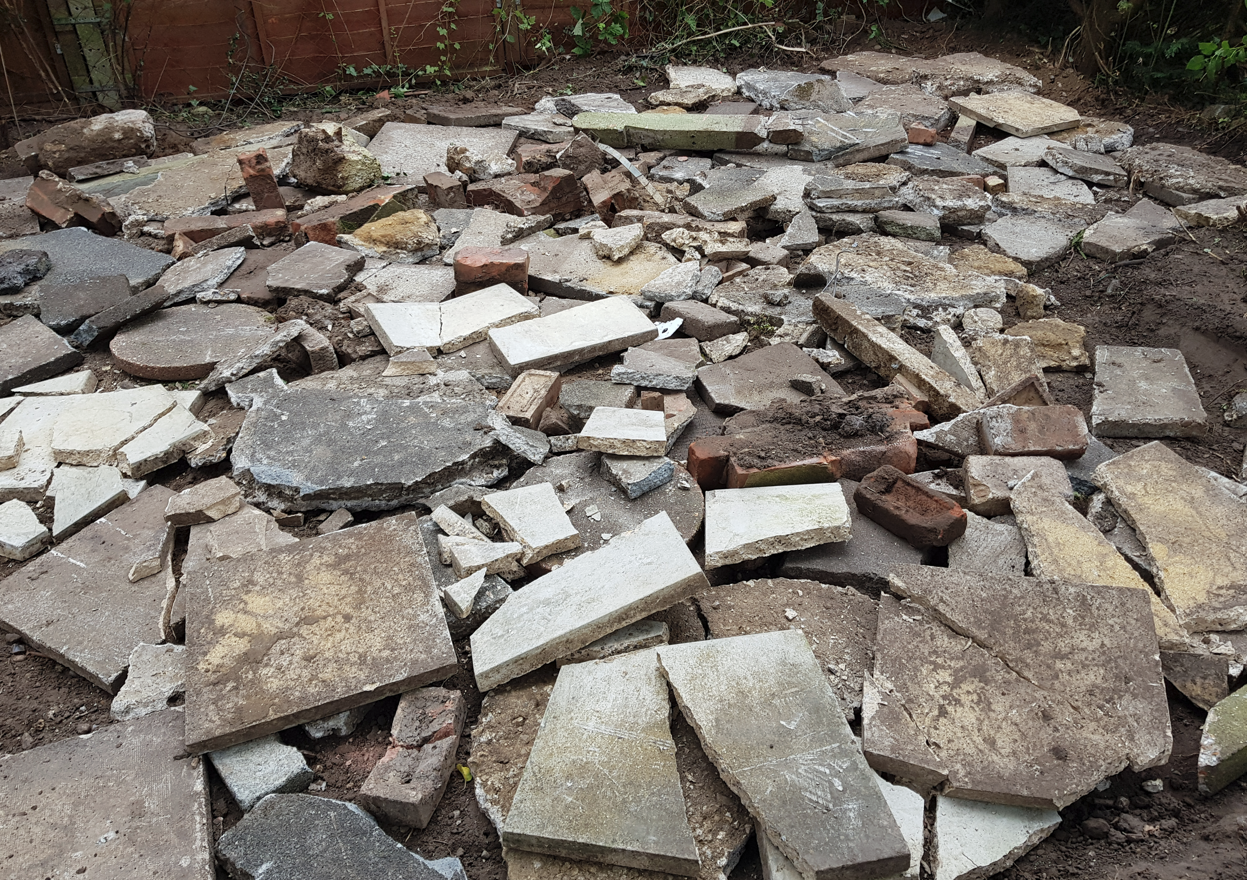 Breaking up and lifting an old patio ready for muck away