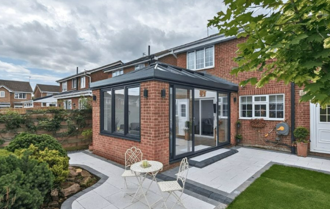 Solid-roof conservatory built on a new brick base and foundations