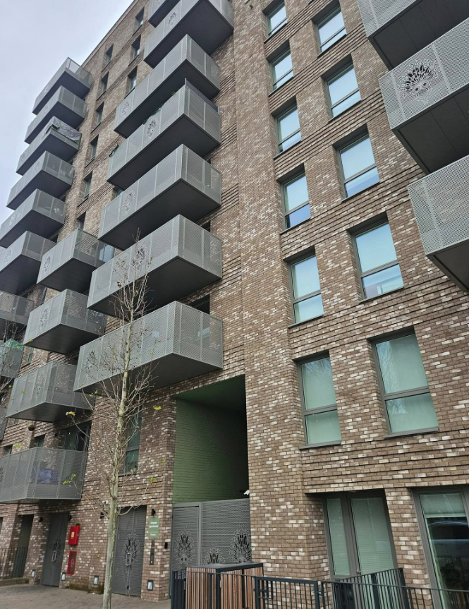 Close view of the brick and perforated-panel facade
