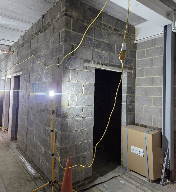 Night-time blockwork corridor build with temporary lighting