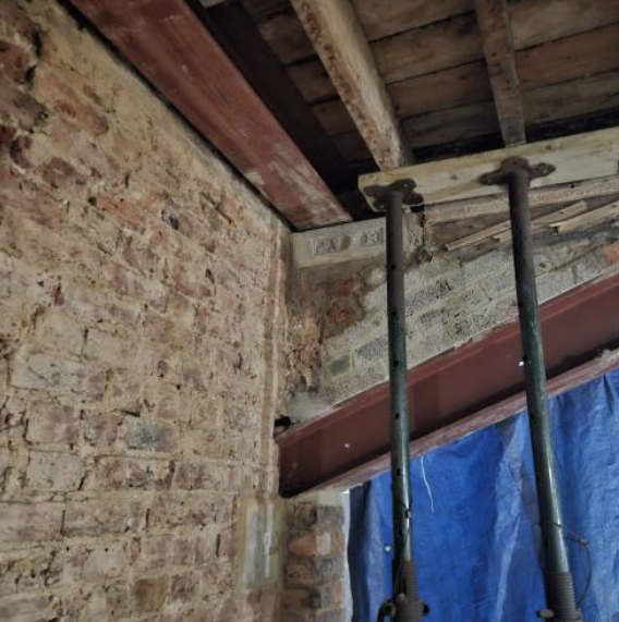 Original brickwork exposed around the new structural opening