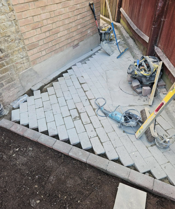 Re-laying block paving around a repaired manhole frame
