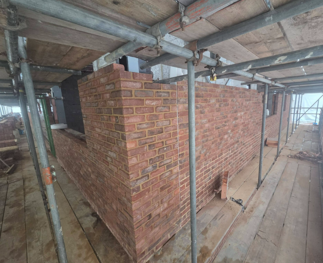 Scaffolded school wall built to specification