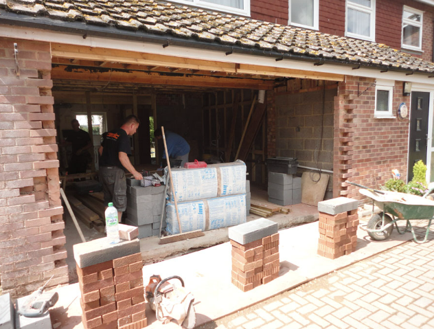 Converting a garage with new brick piers on the driveway