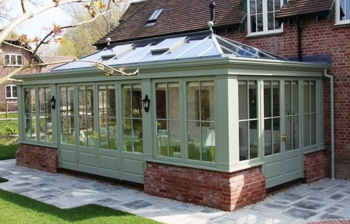 Large conservatory on a brick plinth base with feature dwarf walls