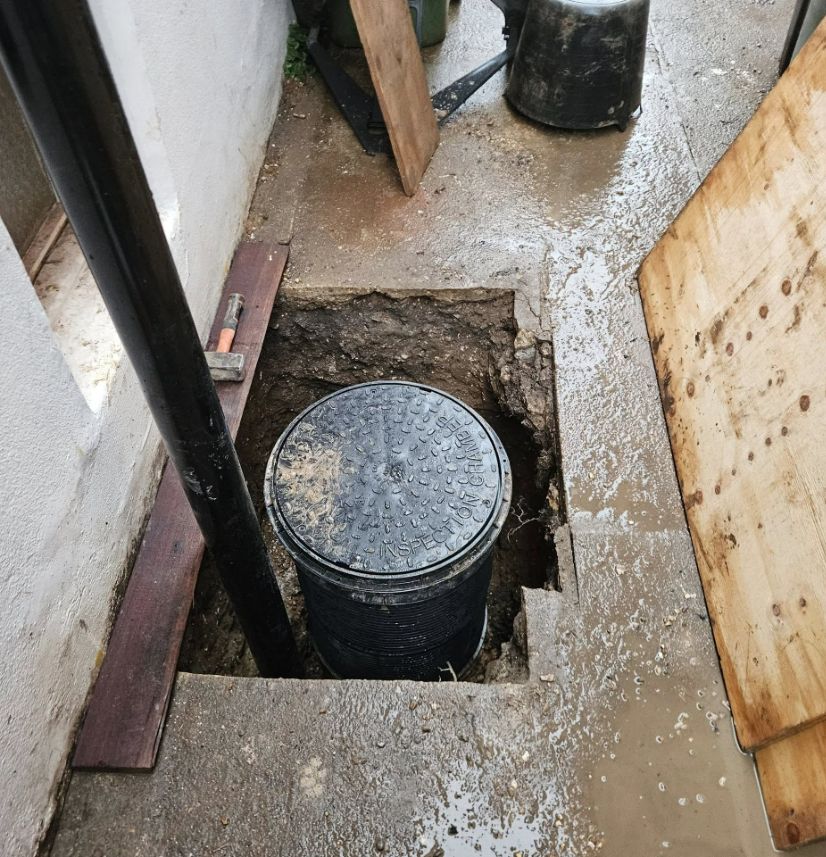 New underground drainage tank set in concrete