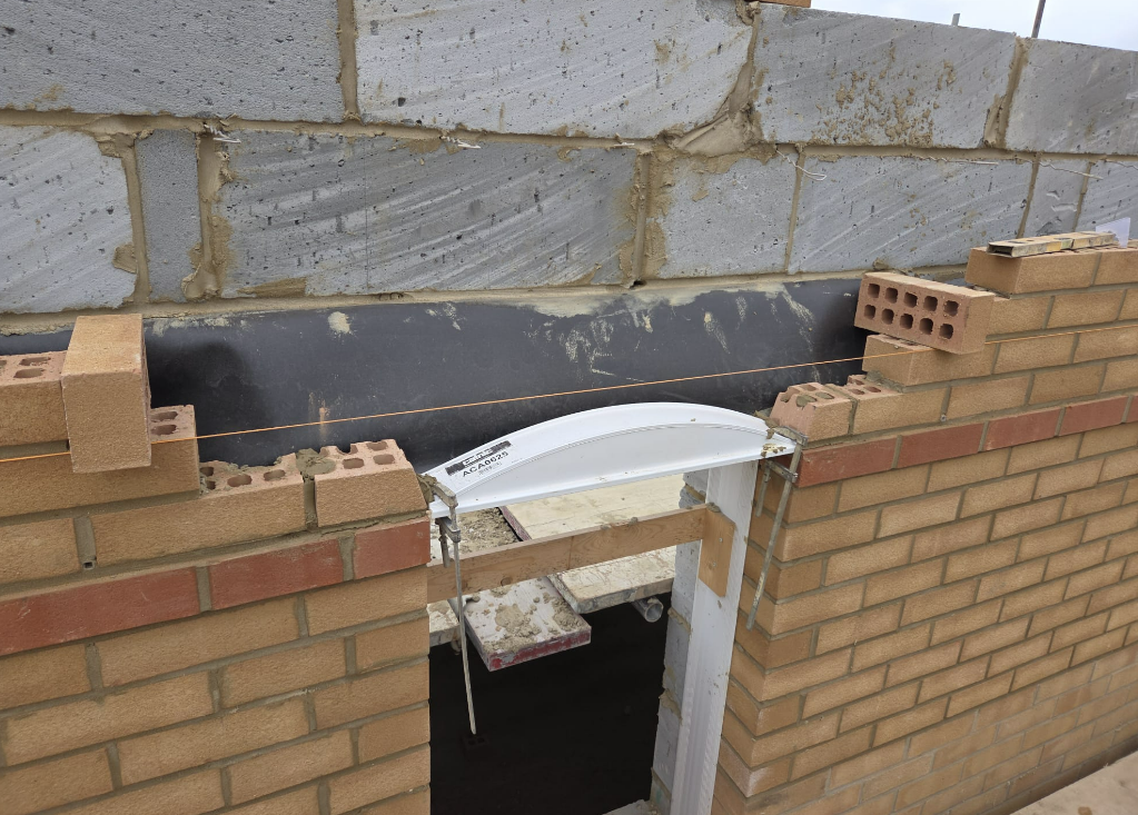 Cavity tray and lintel detail above a door opening