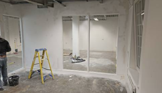 Glazed partition screens forming a bright open-plan workspace
