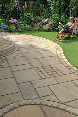 Natural stone paving laid in a curving garden patio