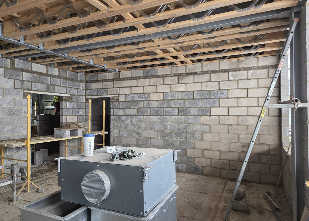 Blockwork and metal stud partitioning beneath a joisted floor