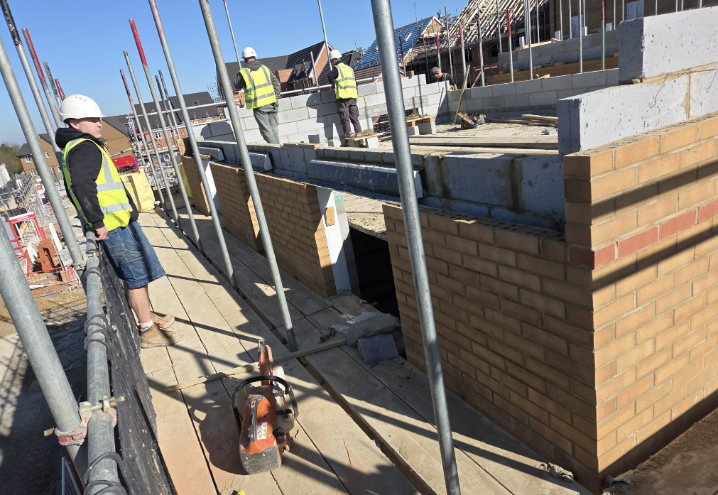 Aerial view of a new-build site with brickwork underway