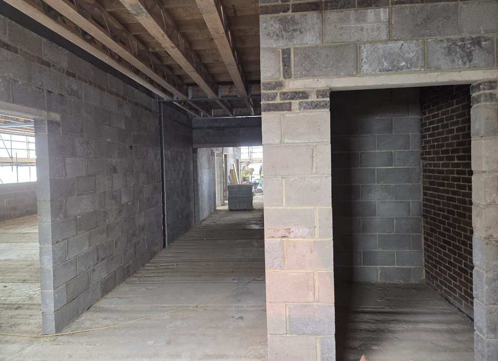 Long blockwork corridor with feature brick piers