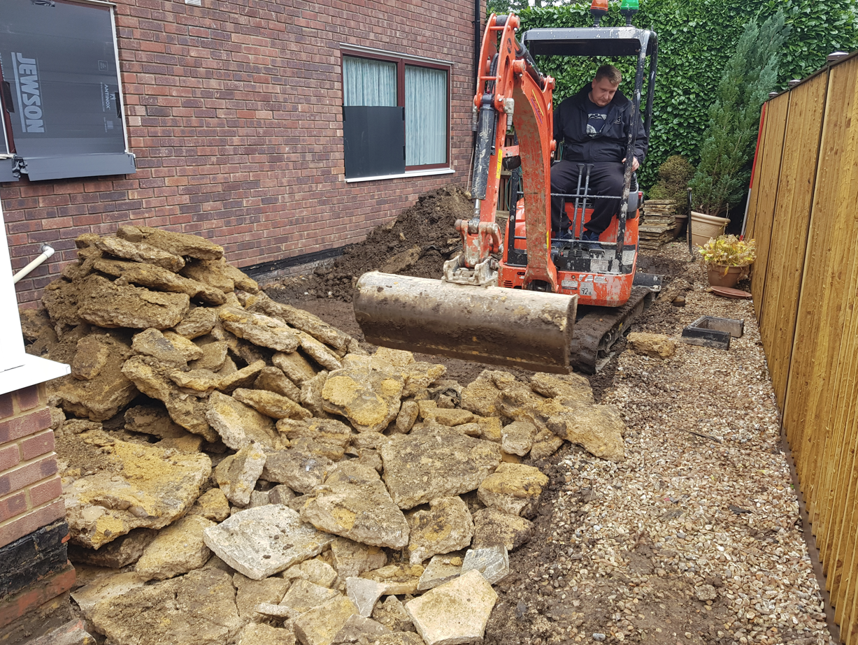 Clearing a broken flag patio and digging out the base