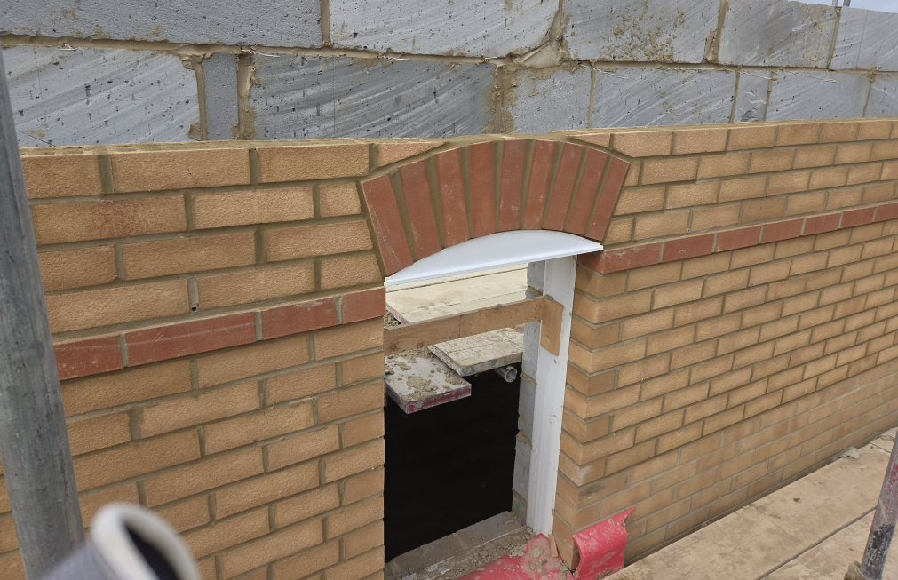 Red-brick arch over a door opening with steel lintel