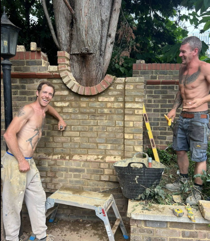 Cutting a brick arch around a tree trunk in a garden wall repair